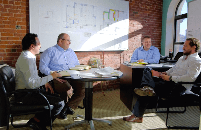 Construction consultant reviewing blueprints